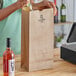 A woman pouring wine from a bottle into a Duro brown paper bag.