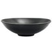 A semi-matte black porcelain bowl with a spiral ink design.