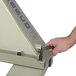 A hand uses a wrench to adjust a Wesco pallet truck.