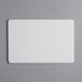 A white rectangular Tomlinson Chef's Edge cutting board.