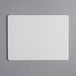 A white rectangular Tomlinson Chef's Edge cutting board with a black border.
