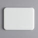 A white rectangular Tomlinson Chef's Edge cutting board.