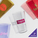 A group of amber Cambro plastic tumblers with a variety of designs.