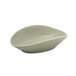 A white porcelain oval ramekin with a curved edge.