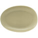 A close-up of the front of a white oval Tides porcelain plate with a shadow.