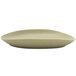 A white oval porcelain plate with a curved edge.