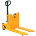 A yellow pallet truck with black handle.