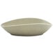 A close-up of a Front of the House Tides semi-matte pumice oval porcelain bowl with a curved edge.