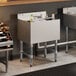 An underbar ice bin with a sliding lid, bottle holders, and a cold plate, designed for bar use.