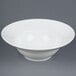 A white CAC porcelain mixing bowl on a gray surface.