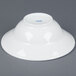 A white CAC porcelain mixing bowl with blue writing on it.