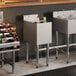 An 18-inch by 12-inch stainless steel underbar ice bin with bottle holders and a sliding lid, designed for bar use.