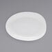 A white oval porcelain plate with a small oval shape on it.