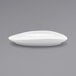 A white Front of the House Tides oval porcelain plate on a gray surface.