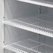 A white Turbo Air TGM-48R refrigerated merchandiser with shelves.