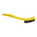 A yellow Rubbermaid tile and grout brush with black plastic bristles.