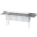 An Advance Tabco stainless steel four-compartment pot sink with two drainboards.