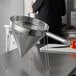 A Choice stainless steel fine china cap strainer and stand set on a counter.