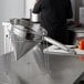 A stainless steel strainer stand on a counter.