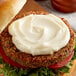 A burger with Heavy Duty Mayonnaise on top.