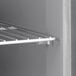 A metal shelf with a white metal rack on it.