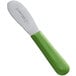 A Dexter-Russell green scalloped sandwich spreader with a green handle and green blade.