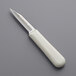 A Dexter-Russell Sani-Safe paring knife with a white handle.