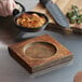 A Valor rubberwood underliner with a bowl of food and a knife on it.