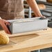 A rectangular glazed aluminized steel Pullman bread loaf pan measuring 16 by 4 by 4 inches, shown with dough inside.
