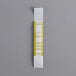 A yellow and white rectangular Mustard currency strap with a white rectangle label with numbers.