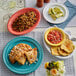 An Acopa Capri oval stoneware platter with rice and beans, salsa, and a glass of ice and lime.