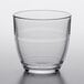 A clear Duralex glass tumbler on a white surface.