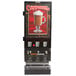 A Bunn hot beverage dispenser with a glass of coffee on top.