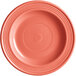 A close-up of an Acopa Capri coral stoneware plate.