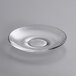 A clear glass saucer with a small circular edge.