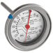 A close-up of a Comark meat thermometer with a red gauge.