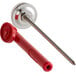 A close-up of a Cooper-Atkins 5" pocket probe dial thermometer with a red and silver object.