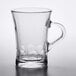 a clear glass cup with a handle