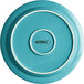 A Caribbean turquoise stoneware plate with white trim and a white circle on the surface.