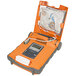 A close-up of an orange and grey Cardiac Science Powerheart G5 AED with a white cord attached.