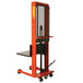 A red and black Wesco hydraulic lift machine with a metal platform.