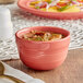 An Acopa Capri coral reef stoneware bouillon bowl of soup on a table.