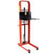 A Wesco black and orange hydraulic platform stacker with a black tray on top.