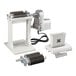 A white Backyard Pro meat tenderizer machine with metal blades and a small metal part.