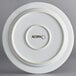 A white stoneware plate with a white rim and the word "Acopa" on it.
