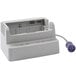 A white rectangular Zoll Single Bay Charging Station with a cord attached.