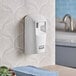 A white Rubbermaid Microburst 3000 wall mounted air freshener system.