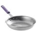 A Vollrath aluminum frying pan with a purple allergen-free sleeve handle.