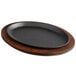 a black round pan on a wood surface