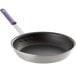 A Vollrath Wear-Ever non-stick aluminum fry pan with a purple handle.